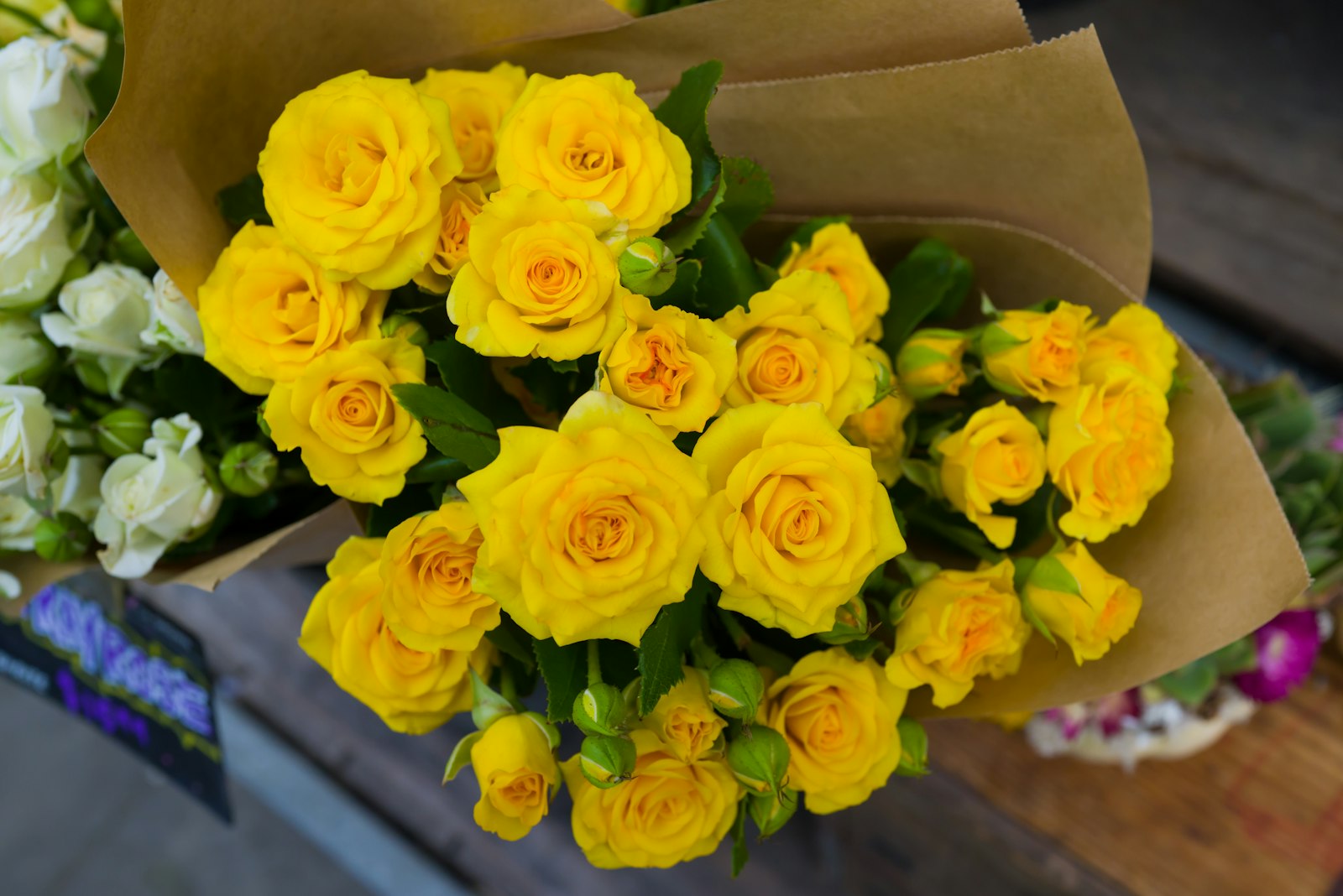Ramo de rosas amarillas envuelto en papel kraft